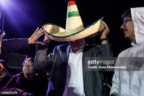 Nevada Gov. Steve Sisolak puts on a sombrero hat and poses with a supporter at the Día De Muertos Camino al Mictlan festival at Freedom Park on...