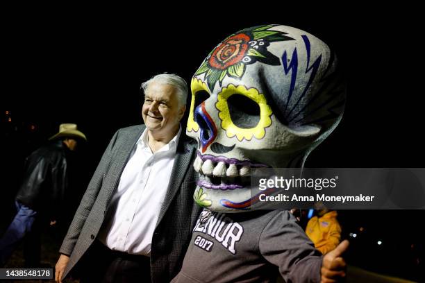 Nevada Gov. Steve Sisolak poses with a supporter wearing a Calavera, which is a representation of a human skull, at the Día De Muertos Camino al...