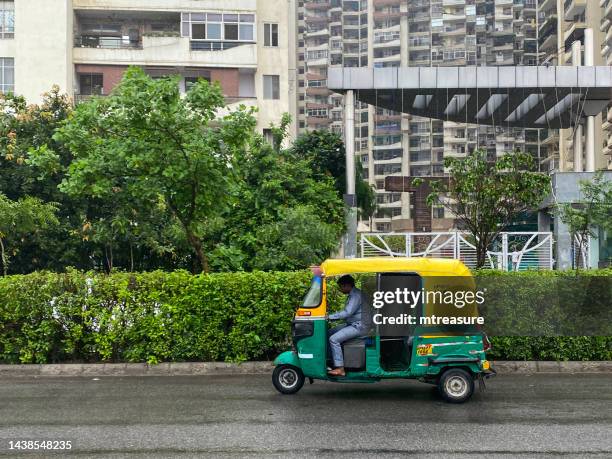 image d’un chauffeur de taxi indien en tuk tuk jaune et vert sans passagers, new delhi, inde - new delhi stock photos et images de collection