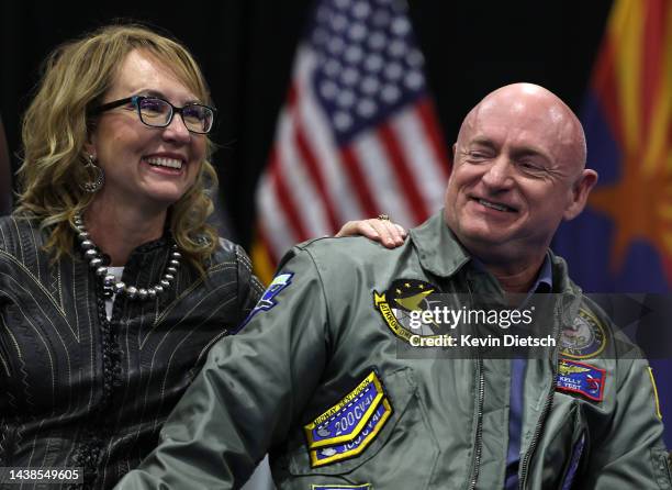 Sen. Mark Kelly and his wife Gabby Giffords, former U.S. Representative, listen as former President Barack Obama speaks at a campaign event at Cesar...