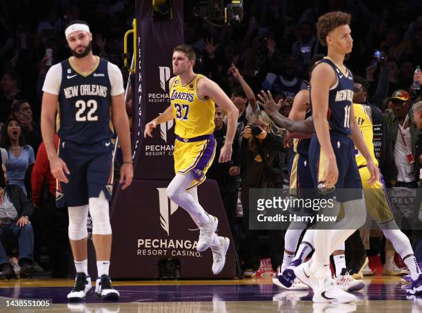 Matt Ryan of the Los Angeles Lakers celebrates his buzzer beating three pointer behind Larry Nance Jr. #22 and Dyson Daniels of the New Orleans...