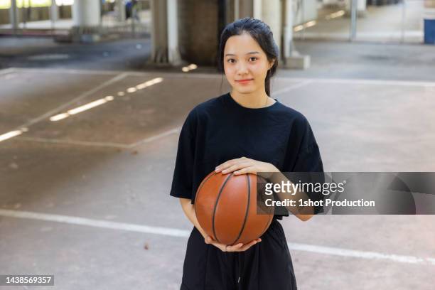 teenage girl with basketball portrait. - basketball teenager stock pictures, royalty-free photos & images