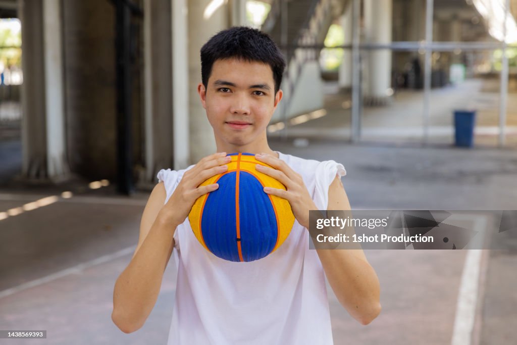 Teenage boy holding a Basketball