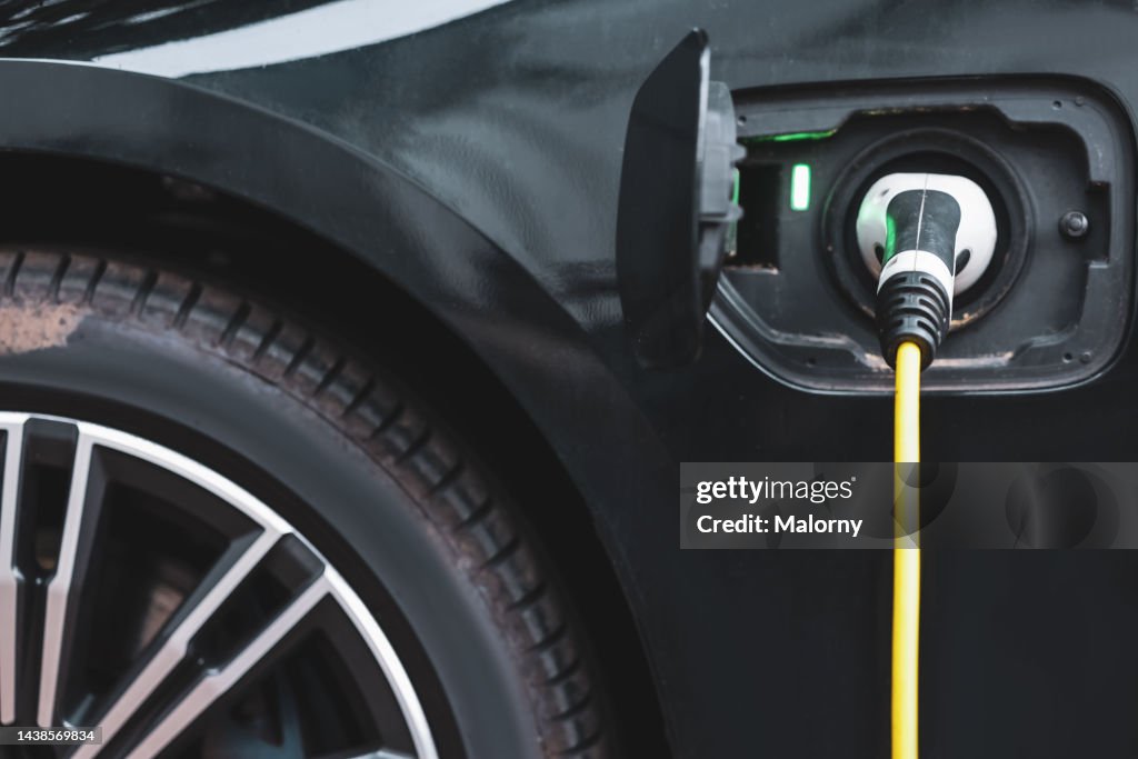 Close-up of electric car charging.
