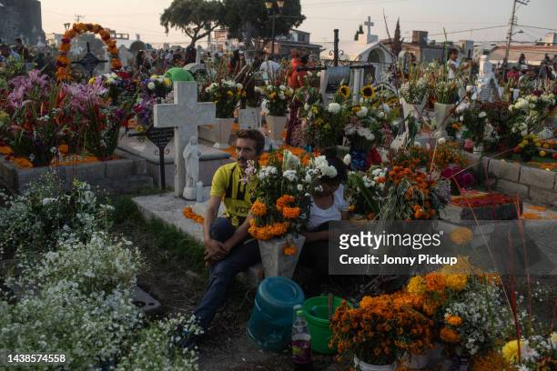Locals attend their relatives gravesduring 'Day of the Dead' celebrations on November 2, 2022 at San Andrés Mixquic graveyard in the outskirts of...