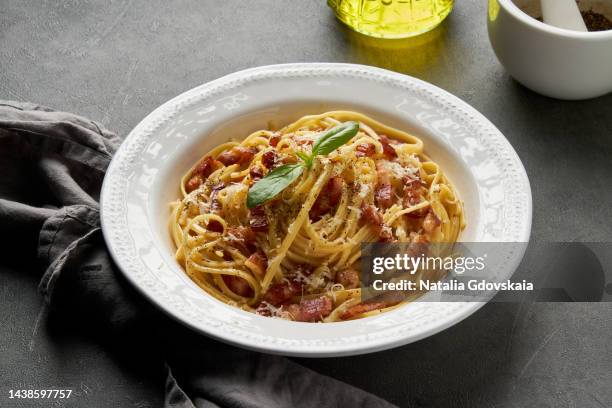 carbonara pasta. spaghetti with pancetta, egg, parmesan cheese and cream sauce. traditional italian cuisine. close-up, side view. - pancetta stock pictures, royalty-free photos & images