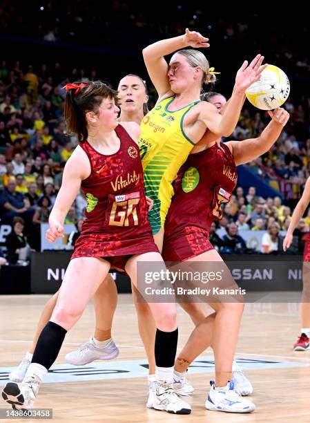 Courtney Bruce of Australia is challenged by Sophie Drakeford-Lewis and Eleanor Cardwell of England during game three of the International Test Match...