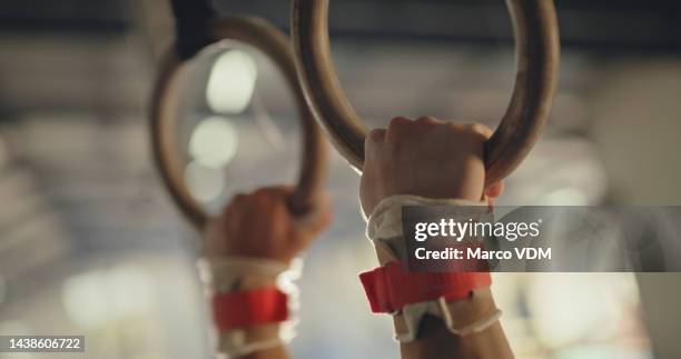 gymnastics rings, hands and exercise for fitness, olympics and talent in sports gym, health club and arena. acrobat, athlete and strong grip action training workout for muscle, power and performance - championship ring stockfoto's en -beelden