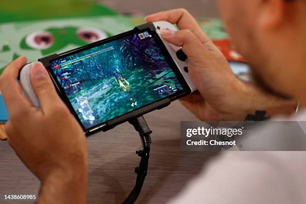 Gamer plays a video game on a Nintendo Switch console, OLED model during Paris Games Week 2022 at Parc des Expositions Porte de Versailles on...