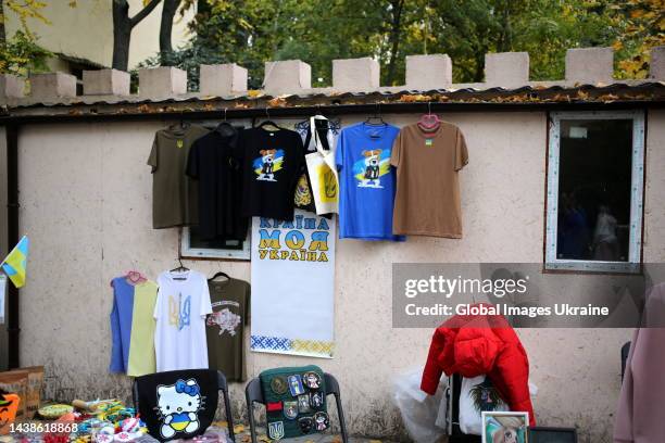 Souvenir products, T-shirts with the state symbols of Ukraine and the dog Patron are presented for sale at a fair organized as part of a charity...