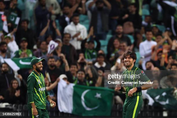 Mohammad Haris of Pakistan celebrates taking a catch with team mate Mohammad Wasim Jr of Pakistan dismissing Anrich Nortje of South Africa off a...