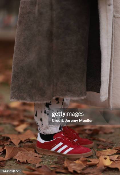 Sonia Lyson is seen wearing Adidas red Gazelle sneaker, Twenty Fall brown long shearling coat, Gucci Attache beige bag, Gobi Cashmere beige hat, Zara...