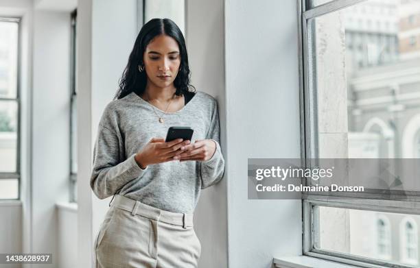 woman, phone and 5g network communication while typing email, social media chat or message by office window. female with smartphone while surfing web, internet and mobile app at work - media profession for women stock pictures, royalty-free photos & images