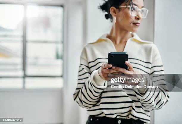 thinking, search and phone with woman at window for communication, technology and contact. app, vision and networking with girl and mobile for online shopping, website and internet in apartment home - privacy policy stockfoto's en -beelden