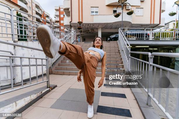 young woman dancing outdoors - break dance city stock pictures, royalty-free photos & images