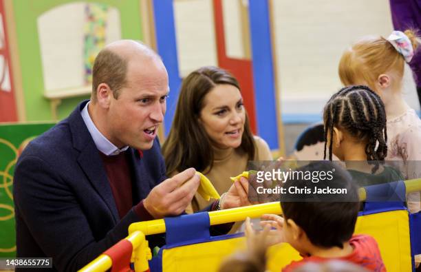 Prince William, Prince of Wales and Catherine, Princess of Wales play with Modelling Dough with children in the Nursery during a visit to The Rainbow...