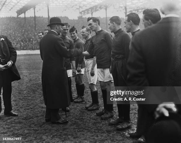 George V meeting Liverpool players ahead of the English League Division One match between Manchester City and Liverpool at City's Hyde Road stadium...
