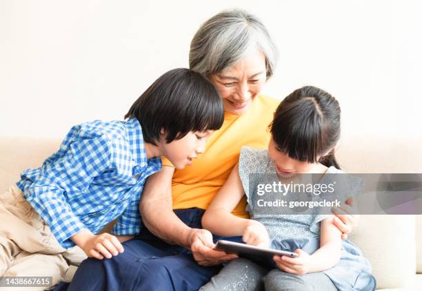 showing grandmother what's on the tablet - old point comfort stock pictures, royalty-free photos & images