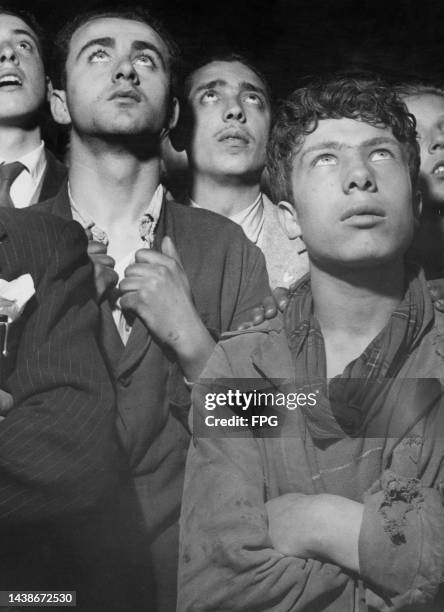 Group of men stand listening to a speech being given by Prime Minister of Italy, Alcide De Gasperi, Italy, circa 1950.