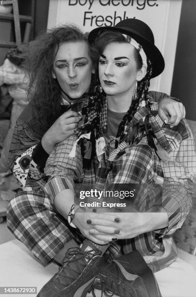 British singer and songwriter Boy George, singer with British pop band Culture Club, poses with his waxwork model at Madame Tussauds in London,...