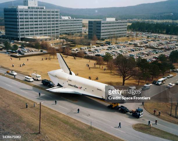 High angle view of the Space Shuttle Orbiter Enterprise passes Building 4200 as it is towed on Rideout Road to Building 4755 ahead of vibration...