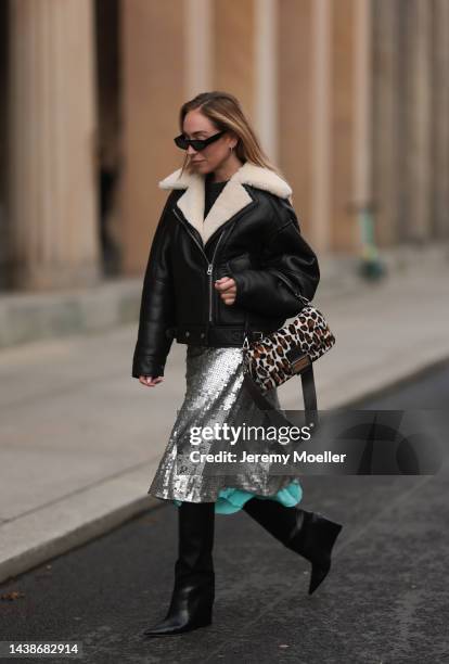 Sonia Lyson seen wearing Fendi animal print baguette bag, Jimmy Choo black boots, Twenty Fall dark brown leather jacket, Fendi sparkling midi skirt...