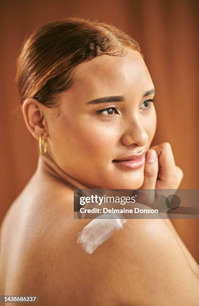 beauty, body lotion cream and woman skincare moisturizer, healthy aesthetic or glowing skin on orange studio background. young female model sunscreen product on shoulder, makeup cosmetics or wellness - orange creme stock pictures, royalty-free photos & images