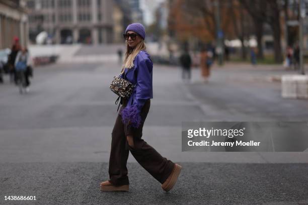 Sonia Lyson seen wearing Ugg plateau platform Ultra Mini beige boots, Storets brown destroyed jogging pants, Storets lilac leather jacket with...