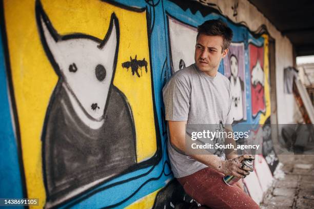 artist with his work - street artist stock pictures, royalty-free photos & images