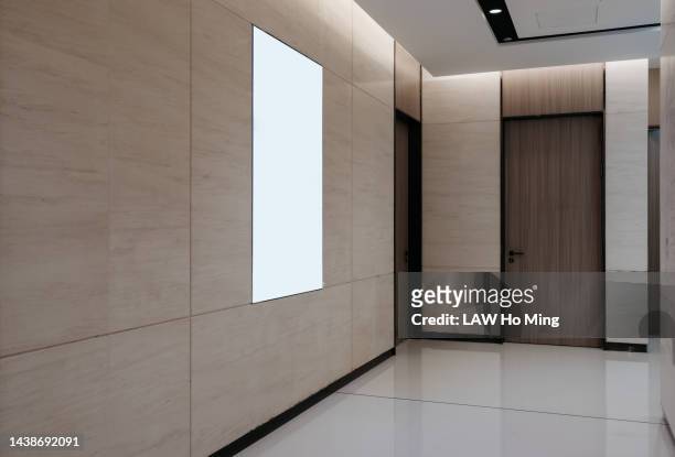 a blank billboard in a clean hallway - airport mockup stock pictures, royalty-free photos & images