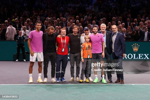 Gilles Simon of France poses for a photo after announcing their retirement alongside family, friends and Felix Auger Aliassime of Canada after being...