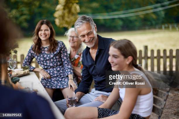 happy family having a garden party - al fresco dining stock pictures, royalty-free photos & images