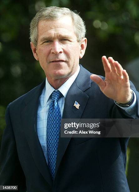 President George W. Bush waves to the media September 30, 2002 after he returned to the White House in Washington, D.C. President Bush spent his...