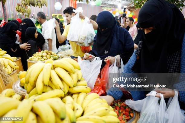 Yemenis shop for vegetables at a market where low prices are set by owners to help improve people's living conditions on November 02, 2022 in Sana'a,...