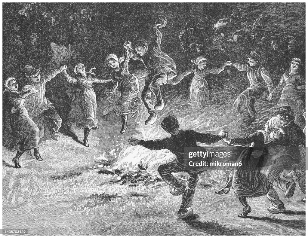 Old engraved illustration of young people dancing around the fire at night