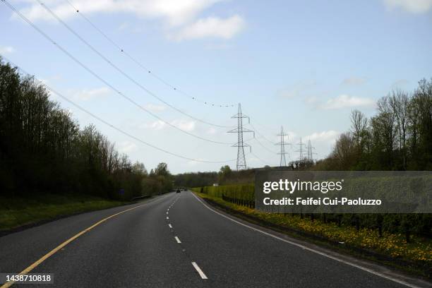 country road and electrical pylon near enniscorthy - electricity stock pictures, royalty-free photos & images