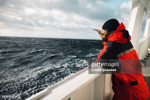 woman researcher on a fishing boat with rough sea - female offshore worker stock pictures, royalty-free photos & images
