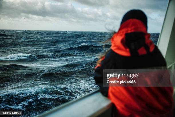 woman fisherman on a fishing boat with rough sea - woman sea stockfoto's en -beelden