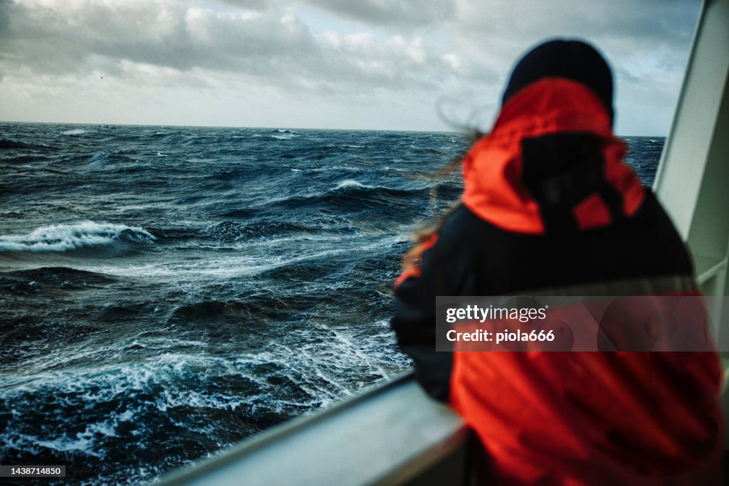 Woman fisherman on a fishing boat with rough sea