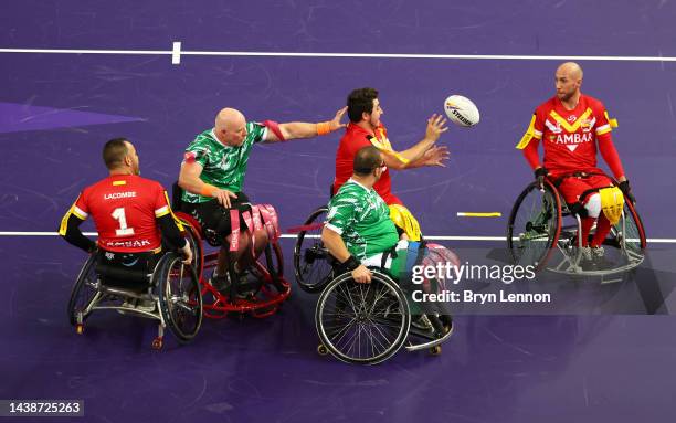 Theo Gonzalez of Spain passes to teammate Yannick Martin while under pressure from Phil Roberts and James McCarthy of Ireland during the Wheelchair...