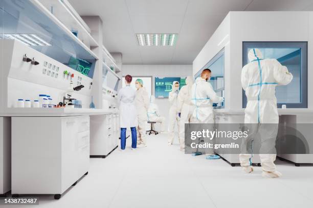 group of scientists working laboratory - macacão de limpeza imagens e fotografias de stock