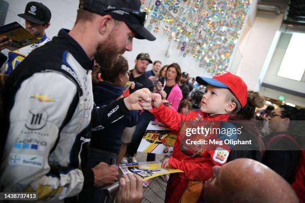 Ross Chastain, driver of the Moose Fraternity Chevrolet, greets a young fan during the NASCAR Championship 4 Media Day at Phoenix Raceway on November...