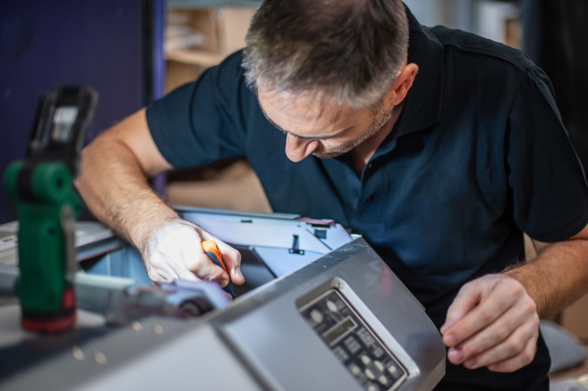 technician repairing sign