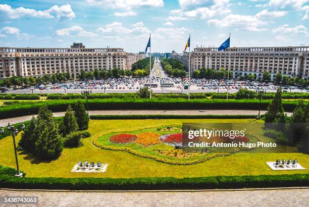 the union boulevards and the flags of romania and european union. bucharest, romania. - the palace of the parliament stock pictures, royalty-free photos & images