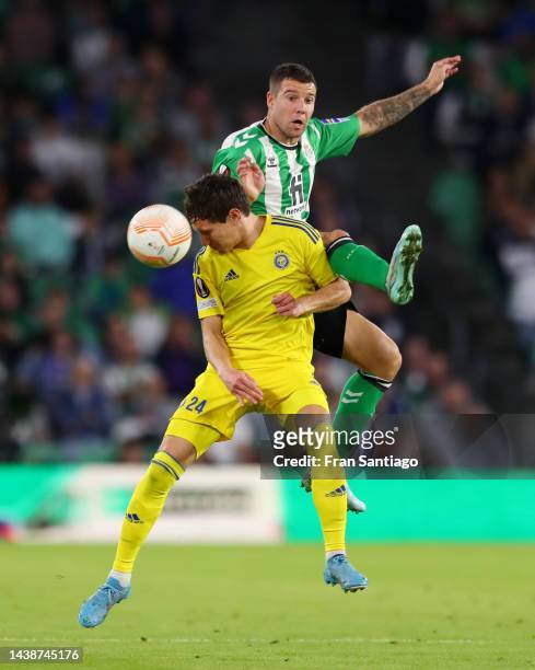 David Browne of HJK Helsinki battles for possession with Aitor Ruibal of Real Betis during the UEFA Europa League group C match between Real Betis...