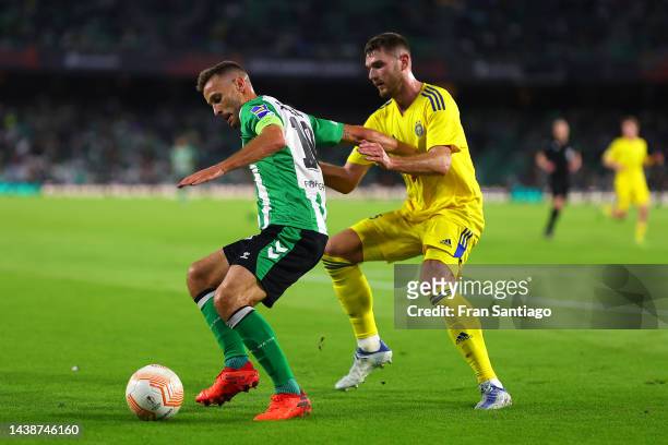 Sergio Canales of Real Betis holds off Arttu Hoskonen of HJK Helsinki during the UEFA Europa League group C match between Real Betis and HJK Helsinki...