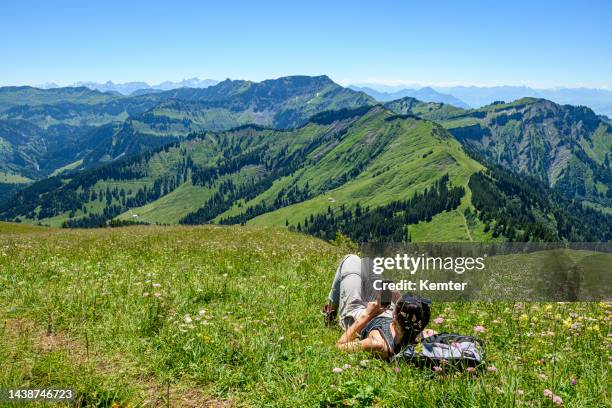 young woman resting in the mountains - vorarlberg imagens e fotografias de stock