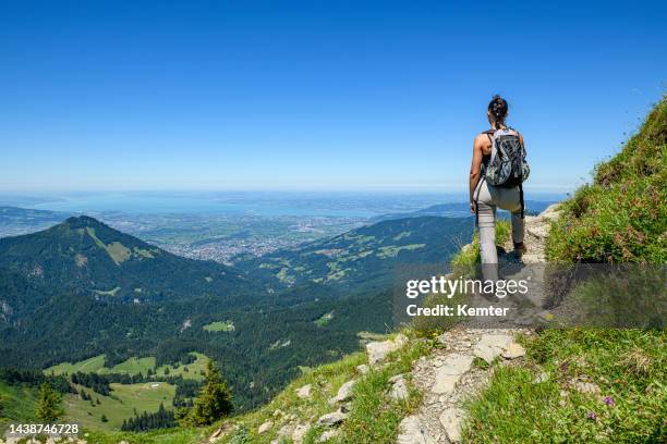 young woman hiking in the mountains - vorarlberg imagens e fotografias de stock