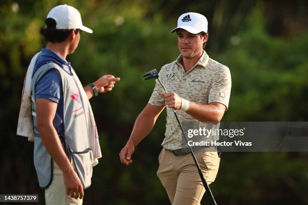 Sebastian Vazquez of Mexico talks to his caddie during the first round of the World Wide Technology Championship at Club de Gold El Camaleon on...