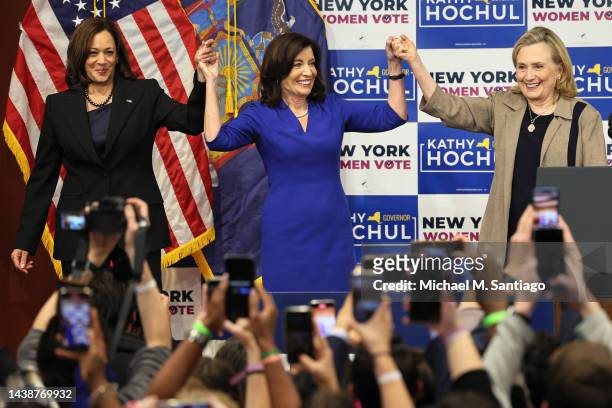 Vice President Kamala Harris, Gov. Kathy Hochul and Secretary Hillary Rodham Clinton hold up their hands at the conclusion of a New York Women “Get...